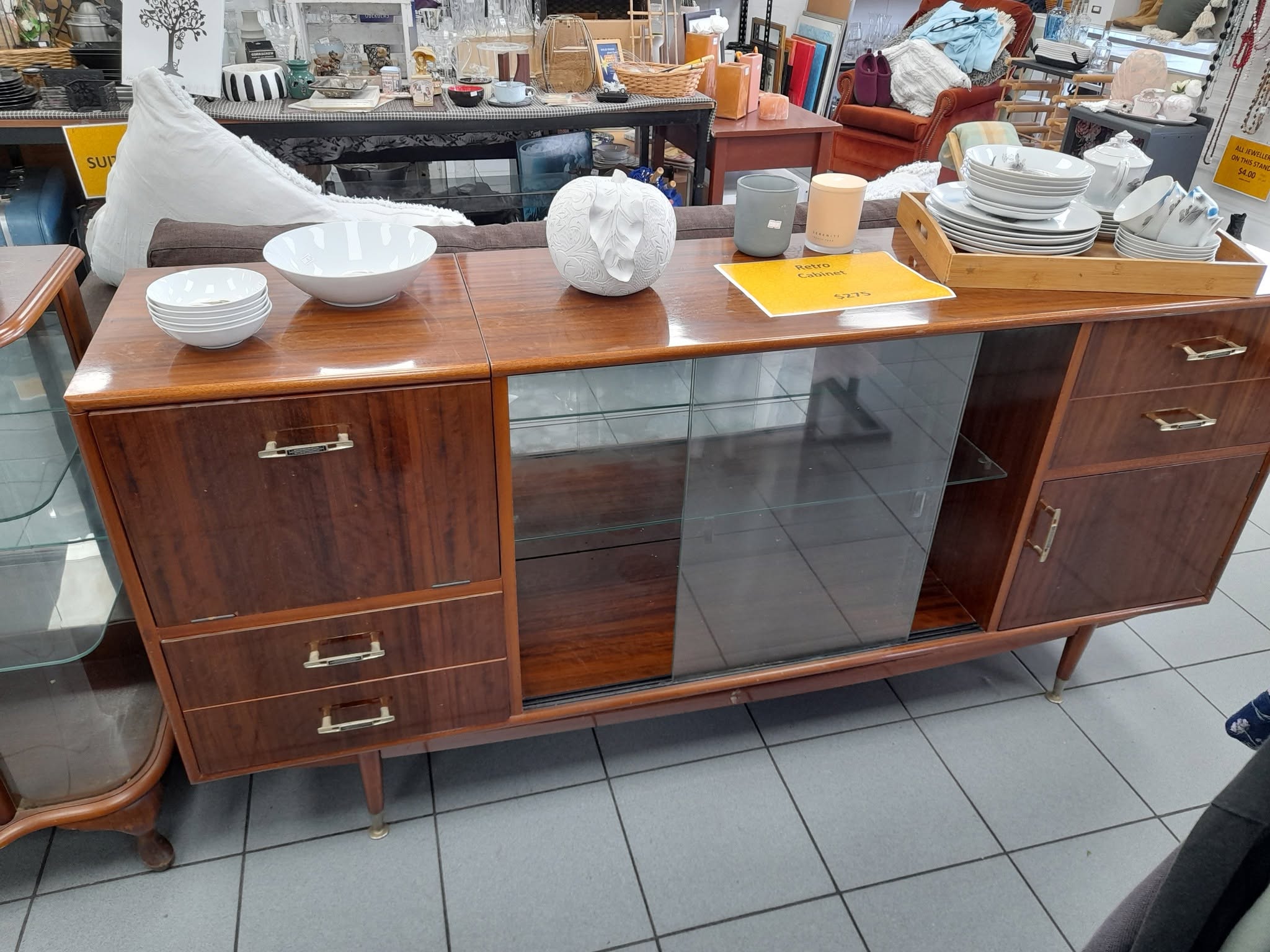 New furniture and homewares are in store at St John Ferry Road, including a rimu display cabinet priced at $275. Clothing is buy two items and get a third item of equal or lesser value free.