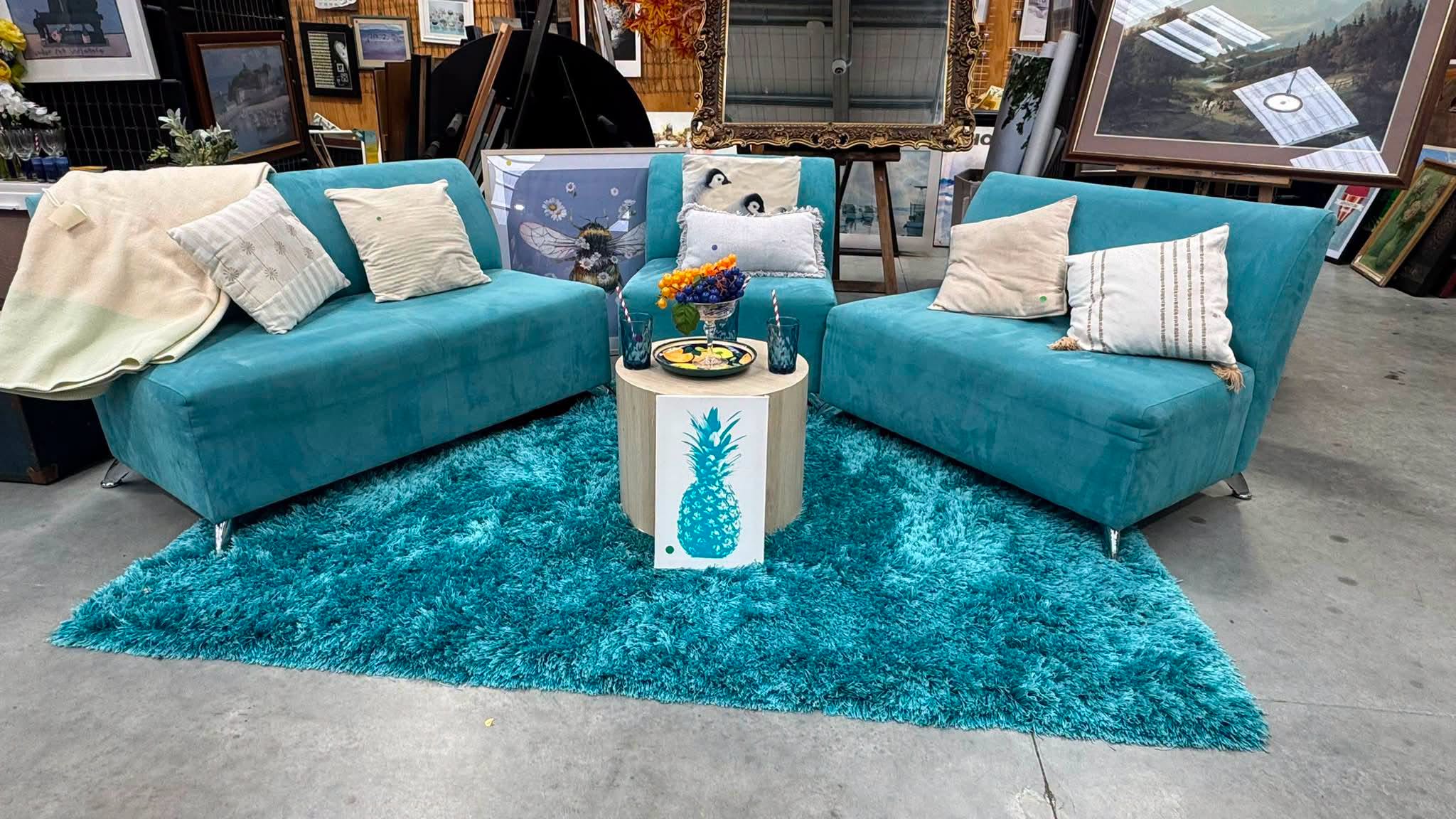 A colourful living-room setup has just reached the floor at Tipping Point Henderson, with teal lounge chairs, a matching rug and coordinating décor.