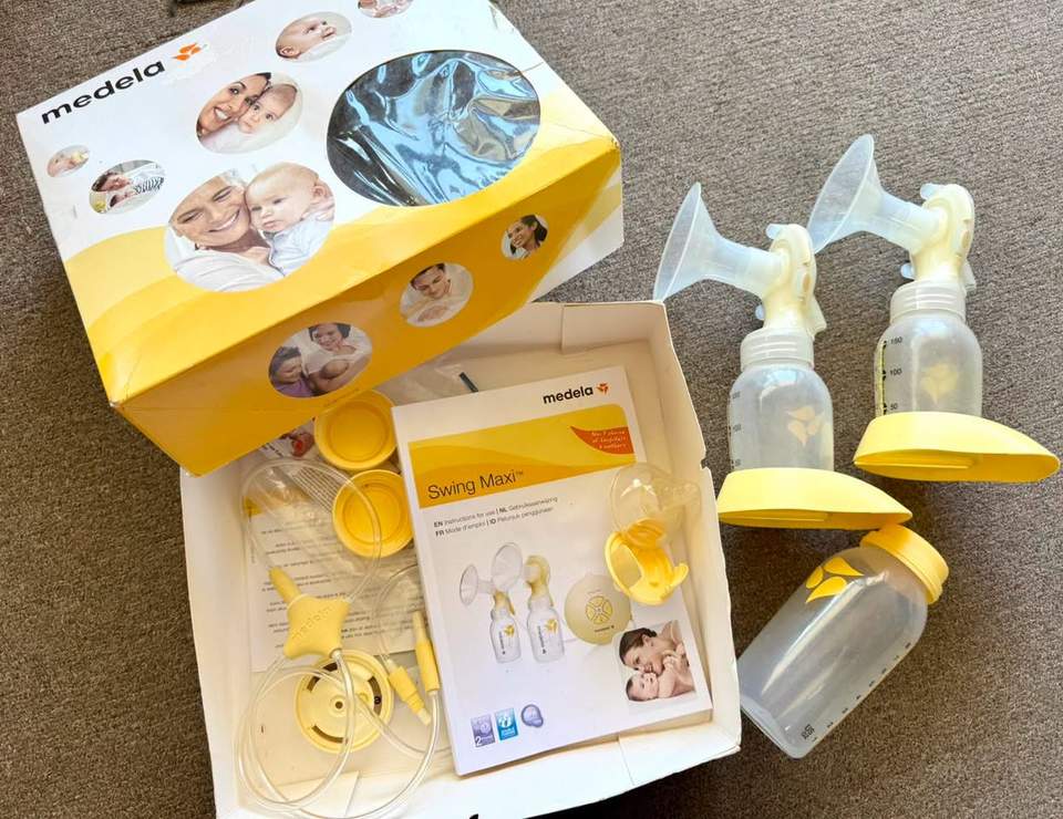 Medela Swing Maxi™ Double Electric Breast Pump set, including the electric motor unit, power adapter, tubing, two PersonalFit Flex breast shield assemblies, bottles