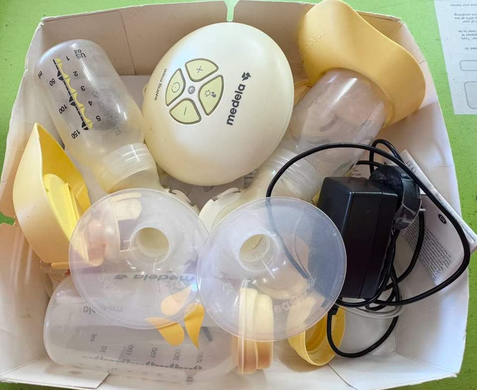 Medela Swing Maxi™ Double Electric Breast Pump set, including the electric motor unit, power adapter, tubing, two PersonalFit Flex breast shield assemblies, bottles