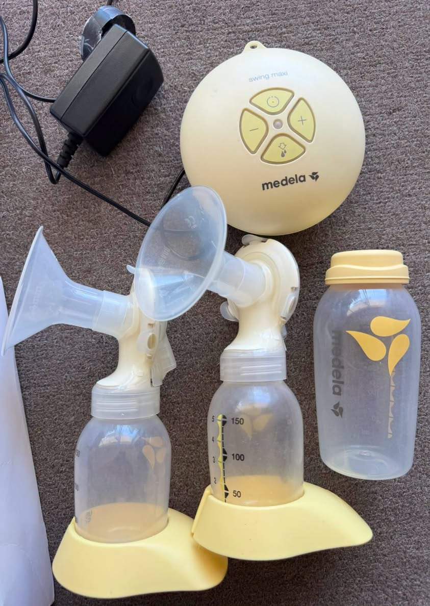 Medela Swing Maxi™ Double Electric Breast Pump set, including the electric motor unit, power adapter, tubing, two PersonalFit Flex breast shield assemblies, bottles