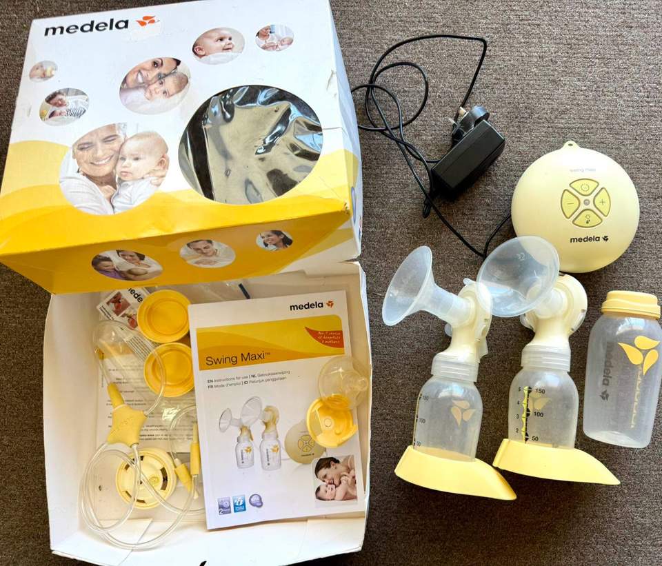 Medela Swing Maxi™ Double Electric Breast Pump set, including the electric motor unit, power adapter, tubing, two PersonalFit Flex breast shield assemblies, bottles