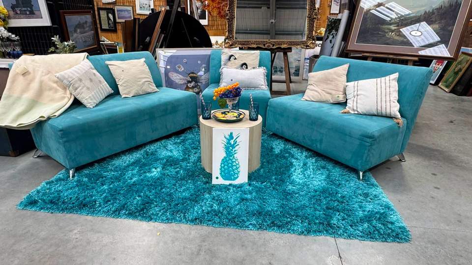 A colourful living-room setup has just reached the floor at Tipping Point Henderson, with teal lounge chairs, a matching rug and coordinating décor.