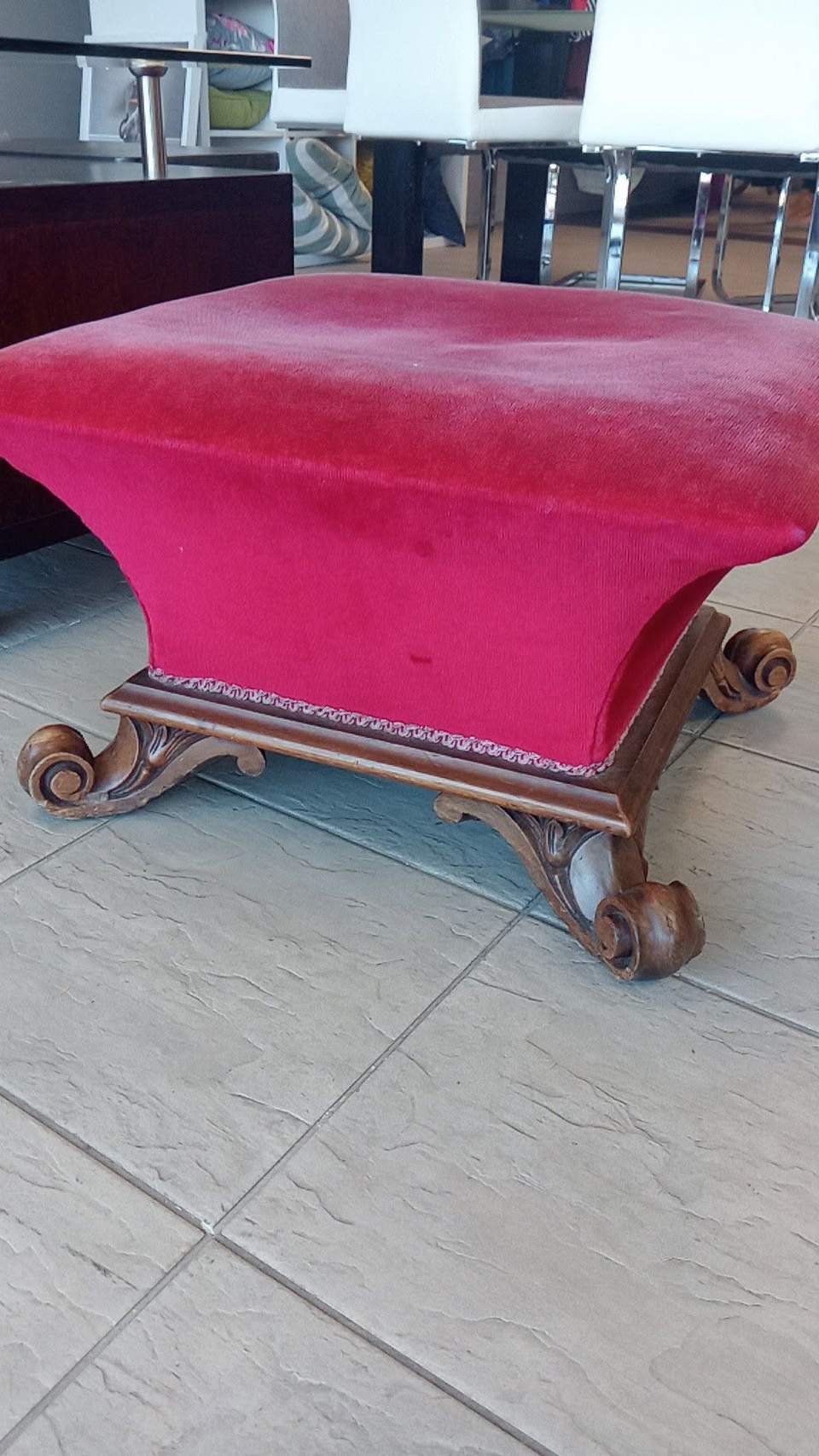 A pink upholstered ottoman is $40 at Blenheim Family Store.